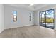 Bright bedroom features tile floors, tray ceiling with fan, and sliding doors to the pool deck at 12396 Bacchus Rd, Port Charlotte, FL 33981