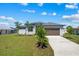 Charming single-Gathering home featuring a well-maintained lawn, two-car garage, and inviting curb appeal at 12396 Bacchus Rd, Port Charlotte, FL 33981