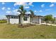 Inviting single-Gathering home with lush green lawn, tasteful landscaping, and a convenient two-car garage at 12396 Bacchus Rd, Port Charlotte, FL 33981