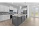 This kitchen features white cabinets, granite countertops, stainless steel appliances, and a center island at 12396 Bacchus Rd, Port Charlotte, FL 33981