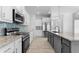 Well-appointed kitchen featuring a center island, stainless steel appliances, and modern fixtures at 12396 Bacchus Rd, Port Charlotte, FL 33981