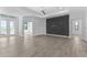 Open floorplan living area with decorative accent wall and tile floors, plus access to other rooms at 12396 Bacchus Rd, Port Charlotte, FL 33981