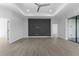 Spacious living room features wood-look tile flooring, recessed lighting, tray ceilings, and a stylish accent wall at 12396 Bacchus Rd, Port Charlotte, FL 33981
