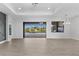 Spacious living room with sliding glass doors to the lanai and pool, plus open access to other rooms at 12396 Bacchus Rd, Port Charlotte, FL 33981