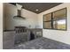 Stylish outdoor kitchen equipped with a built-in grill, sink, and beverage cooler at 12396 Bacchus Rd, Port Charlotte, FL 33981