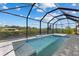 Inviting screened-in pool area with a clear, refreshing pool and peaceful waterfront views at 12396 Bacchus Rd, Port Charlotte, FL 33981