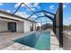 Stunning view of a screened in pool and patio area, complete with waterfront access for tranquil outdoor living at 12396 Bacchus Rd, Port Charlotte, FL 33981