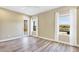 Bright main bedroom with serene lake view, lanai access, and light-colored wood floors at 12717 Deep Blue Pl, Bradenton, FL 34211