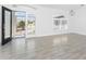 Bright living room featuring tiled floors, an arched window, and double glass doors at 130 Acalypha, Punta Gorda, FL 33955