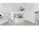 Modern open floor plan featuring tile floors, sleek ceiling fans, and views of the pool area at 130 Acalypha, Punta Gorda, FL 33955