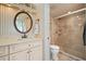 Bathroom featuring a marble tiled shower with a glass door and a white vanity at 1323 Perico Point Cir # 107, Bradenton, FL 34209