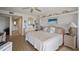 Relaxing bedroom with serene water views and a connecting doorway to the ensuite bathroom and vanity area at 1323 Perico Point Cir # 107, Bradenton, FL 34209