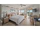 Bright bedroom featuring a waterfront view from a private balcony, natural light, and comfortable seating at 1323 Perico Point Cir # 107, Bradenton, FL 34209