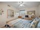 Cozy bedroom with coastal decor, a ceiling fan, and a large window at 1323 Perico Point Cir # 107, Bradenton, FL 34209