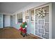 Charming condo entrance with potted flowers, decorative wreath, and a white screen door at 1323 Perico Point Cir # 107, Bradenton, FL 34209