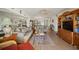 Spacious living area with comfortable seating, a mirrored wall, and sliding doors with scenic views at 1323 Perico Point Cir # 107, Bradenton, FL 34209