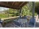 Charming covered patio with seating area overlooking the lush tropical landscape at 1601 Pelican Point Dr # Ha213, Sarasota, FL 34231