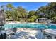 Large community pool with plenty of seating and lush landscaping creates a relaxing, resort-like atmosphere at 1601 Pelican Point Dr # Ha213, Sarasota, FL 34231