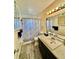 Neutral bathroom features gray vinyl flooring, a vanity with storage, and a shower-tub combo at 1633 Leisure Dr # M-37, Bradenton, FL 34207