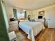 Bedroom with a queen bed, wood floors, and a large window provides a warm and inviting ambiance at 1633 Leisure Dr # M-37, Bradenton, FL 34207