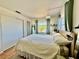 Sun-filled bedroom showcases natural light, wood floors, closet, and soothing blue accents for a serene retreat at 1633 Leisure Dr # M-37, Bradenton, FL 34207