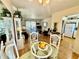 Bright dining area with a glass table, flowing into a comfortable living room and open kitchen at 1633 Leisure Dr # M-37, Bradenton, FL 34207