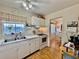 Cozy kitchen with white cabinets, double sink, and bright natural light streaming through the window at 1633 Leisure Dr # M-37, Bradenton, FL 34207