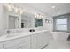 Elegant bathroom showcasing a double vanity with modern fixtures, a freestanding tub, and stylish decor at 1647 Siesta Dr, Sarasota, FL 34239