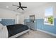 Bedroom featuring decoratively painted walls, ceiling fan, wood floors, and a dresser at 1647 Siesta Dr, Sarasota, FL 34239