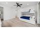 Bedroom featuring a bunk bed, ceiling fan, and light wood floors at 1647 Siesta Dr, Sarasota, FL 34239