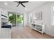 Light-filled bedroom with balcony access, ceiling fan, and wood floors at 1647 Siesta Dr, Sarasota, FL 34239