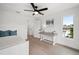Well-lit bedroom with a ceiling fan, a desk, and a window providing ample natural light at 1647 Siesta Dr, Sarasota, FL 34239