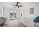 Bright bedroom with a ceiling fan, access to a balcony, and a trundle daybed at 1647 Siesta Dr, Sarasota, FL 34239