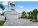 Beautiful light blue two-story home with a two-car garage and driveway at 1647 Siesta Dr, Sarasota, FL 34239