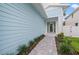 Charming home showcasing a front door and walkway bordered by lush plants, providing a welcoming entrance at 1647 Siesta Dr, Sarasota, FL 34239