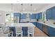 Spacious kitchen with a large island, stainless steel appliances, and stylish blue cabinetry at 1647 Siesta Dr, Sarasota, FL 34239
