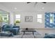 Contemporary living room boasting white walls, recessed lighting, and a sliding glass door for seamless indoor-outdoor living at 1647 Siesta Dr, Sarasota, FL 34239