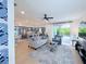 Bright, open living room featuring a modern kitchen, comfortable seating, and sliding doors to the pool area at 1647 Siesta Dr, Sarasota, FL 34239