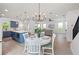 Open-concept kitchen, dining, and living area with wood flooring and plenty of natural light at 1647 Siesta Dr, Sarasota, FL 34239