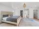 Bright main bedroom with a tray ceiling, recessed lighting, and views to the hallway and closets at 1647 Siesta Dr, Sarasota, FL 34239