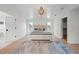 Well-lit main bedroom with white walls, an elegant ceiling fixture, and views to the main bathroom at 1647 Siesta Dr, Sarasota, FL 34239