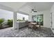 Covered outdoor kitchen and patio with dining area, grill, and sink, perfect for entertaining in a home's outdoor space at 1647 Siesta Dr, Sarasota, FL 34239