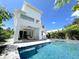 Stunning backyard pool with luxurious lounge chairs and an outdoor dining area, perfect for relaxation and entertaining at 1647 Siesta Dr, Sarasota, FL 34239