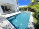Beautiful backyard pool with lounge chairs, hot tub, and outdoor dining, perfect for relaxing and entertaining at 1647 Siesta Dr, Sarasota, FL 34239