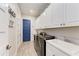 A well-organized laundry room with sleek washer and dryer, ample storage and bright white cabinets at 1709 6Th E St, Palmetto, FL 34221