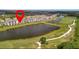 Aerial view of a residential building with a golf course and pond at 17626 Gawthrop Dr # 305, Bradenton, FL 34211