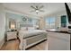 Well-lit bedroom with a bed, dresser, nightstands and wood flooring at 17626 Gawthrop Dr # 305, Bradenton, FL 34211