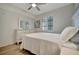 Bright bedroom featuring a large window with shutters and a light-colored wood floor at 17626 Gawthrop Dr # 305, Bradenton, FL 34211