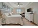 Spacious bedroom featuring a large bed, wood floors, and a mounted television at 17626 Gawthrop Dr # 305, Bradenton, FL 34211