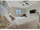 Bright bedroom featuring a large bed, wood floors, and a mounted television at 17626 Gawthrop Dr # 305, Bradenton, FL 34211